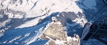 Movie still from “On Her Majesty's Secret Service” (1969), directed by Peter R. Hunt – A view of a mountain from a high point; Extreme Wide shot, Low angle