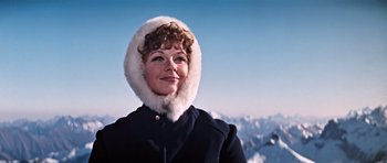 Movie still from “On Her Majesty's Secret Service” (1969), directed by Peter R. Hunt – A woman in a fur trimmed coat on top of a mountain; Close Up shot, Low angle