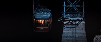 Movie still from “On Her Majesty's Secret Service” (1969), directed by Peter R. Hunt – A cable car on the tracks at night time; Extreme Wide shot, High angle