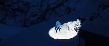 Movie still from “On Her Majesty's Secret Service” (1969), directed by Peter R. Hunt – A man riding skis down a snow covered slope; Extreme Wide shot, High angle