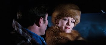 Movie still from “On Her Majesty's Secret Service” (1969), directed by Peter R. Hunt – A man and a woman in a fur hat; Close Up shot, Over the shoulder angle