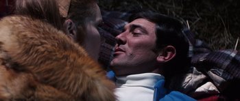 Movie still from “On Her Majesty's Secret Service” (1969), directed by Peter R. Hunt – A man and a woman face to face in the dark; Close Up shot, Low angle