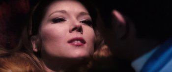 Movie still from “On Her Majesty's Secret Service” (1969), directed by Peter R. Hunt – A woman's face in the dark; Extreme Close Up shot, Over the shoulder angle
