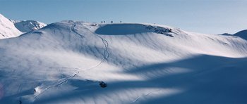 Movie still from “On Her Majesty's Secret Service” (1969), directed by Peter R. Hunt – A group of skiers on a snowy slope; Extreme Wide shot, High angle