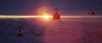 Movie still from “On Her Majesty's Secret Service” (1969), directed by Peter R. Hunt – A helicopter is flying over a mountain range; Extreme Wide shot, High angle