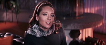 Movie still from “On Her Majesty's Secret Service” (1969), directed by Peter R. Hunt – A woman in a black shirt and a fur collar; Close Up shot, Low angle