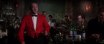 Movie still from “On a Clear Day You Can See Forever” (1970), directed by Vincente Minnelli – A group of men sitting around a table; Medium shot, Low angle