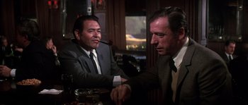 Movie still from “On a Clear Day You Can See Forever” (1970), directed by Vincente Minnelli – Two men sitting at a table in a restaurant; Medium shot, Over the shoulder angle