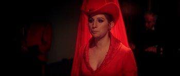 Movie still from “On a Clear Day You Can See Forever” (1970), directed by Vincente Minnelli – A woman wearing a red dress and a red hat; Close Up shot, Over the shoulder angle