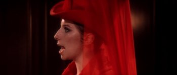 Movie still from “On a Clear Day You Can See Forever” (1970), directed by Vincente Minnelli – A person wearing a red hat; Close Up shot, Over the shoulder angle