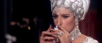 Movie still from “On a Clear Day You Can See Forever” (1970), directed by Vincente Minnelli – A woman in a tiara holding a glass of wine; Close Up shot, Over the shoulder angle