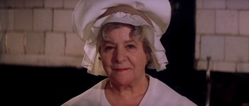 Movie still from “On a Clear Day You Can See Forever” (1970), directed by Vincente Minnelli – An older woman wearing a white dress and a white hat; Close Up shot, Low angle