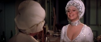 Movie still from “On a Clear Day You Can See Forever” (1970), directed by Vincente Minnelli – A woman wearing a white dress and a white hat; Close Up shot, Over the shoulder angle