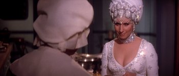 Movie still from “On a Clear Day You Can See Forever” (1970), directed by Vincente Minnelli – A woman in a white dress and a white hat; Close Up shot, Over the shoulder angle