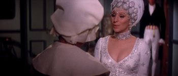 Movie still from “On a Clear Day You Can See Forever” (1970), directed by Vincente Minnelli – A person wearing a dress and a headpiece; Close Up shot, Over the shoulder angle