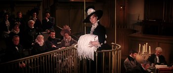 Movie still from “On a Clear Day You Can See Forever” (1970), directed by Vincente Minnelli – A woman in a black and white dress and a hat; Medium shot, Low angle