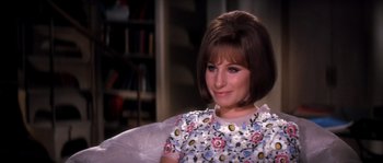 Movie still from “On a Clear Day You Can See Forever” (1970), directed by Vincente Minnelli – A woman sitting in a chair wearing a floral dress; Close Up shot, High angle