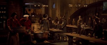 Movie still from “On a Clear Day You Can See Forever” (1970), directed by Vincente Minnelli – A group of people gathered around a large cooking pot; Wide shot, High angle