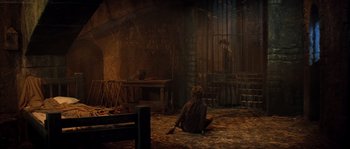 Movie still from “On a Clear Day You Can See Forever” (1970), directed by Vincente Minnelli – A woman sitting on the ground in a room; Wide shot, High angle