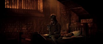 Movie still from “On a Clear Day You Can See Forever” (1970), directed by Vincente Minnelli – A woman sitting on a bed holding a brush; Medium shot, High angle