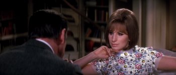 Movie still from “On a Clear Day You Can See Forever” (1970), directed by Vincente Minnelli – A man and a woman are sitting in front of each other; Close Up shot, Over the shoulder angle