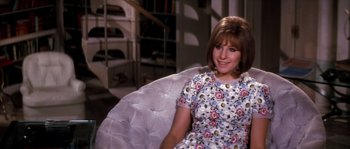 Movie still from “On a Clear Day You Can See Forever” (1970), directed by Vincente Minnelli – A woman sitting on a chair in a room; Medium shot, High angle