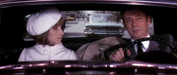 Movie still from “On a Clear Day You Can See Forever” (1970), directed by Vincente Minnelli – A man and a woman in the back seat of a car; Medium shot, Over the shoulder angle