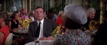 Movie still from “On a Clear Day You Can See Forever” (1970), directed by Vincente Minnelli – A man sitting at a table with a woman in front of him; Medium shot, Over the shoulder angle