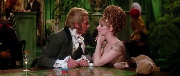 Movie still from “On a Clear Day You Can See Forever” (1970), directed by Vincente Minnelli – A man and a woman sitting at a table; Medium shot, Over the shoulder angle