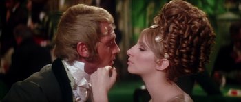 Movie still from “On a Clear Day You Can See Forever” (1970), directed by Vincente Minnelli – A man and a woman are kissing each other; Close Up shot, Over the shoulder angle