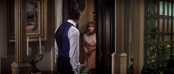 Movie still from “On a Clear Day You Can See Forever” (1970), directed by Vincente Minnelli – A man and a woman standing in front of a door; Medium shot, Over the shoulder angle