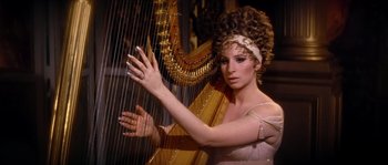 Movie still from “On a Clear Day You Can See Forever” (1970), directed by Vincente Minnelli – A woman in a white dress is playing a harp; Close Up shot, Over the shoulder angle