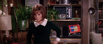 Movie still from “On a Clear Day You Can See Forever” (1970), directed by Vincente Minnelli – A woman in a black dress and white collar; Medium shot, Over the shoulder angle