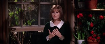 Movie still from “On a Clear Day You Can See Forever” (1970), directed by Vincente Minnelli – A young woman standing in front of an open window; Medium shot, Over the shoulder angle