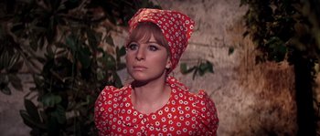Movie still from “On a Clear Day You Can See Forever” (1970), directed by Vincente Minnelli – A woman wearing a red dress and a head scarf; Close Up shot, High angle