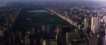 Movie still from “On a Clear Day You Can See Forever” (1970), directed by Vincente Minnelli – An aerial view of a large city with trees in the background; Extreme Wide shot, High angle