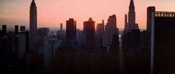 Movie still from “On a Clear Day You Can See Forever” (1970), directed by Vincente Minnelli – The sun is setting over a city skyline; Extreme Wide shot, High angle