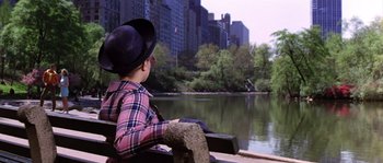 Movie still from “On a Clear Day You Can See Forever” (1970), directed by Vincente Minnelli – A boy sitting on a bench looking out at a river; Wide shot, High angle