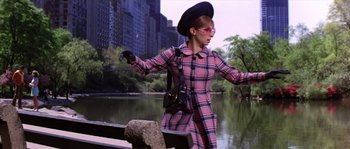 Movie still from “On a Clear Day You Can See Forever” (1970), directed by Vincente Minnelli – A woman in a pink plaid dress and a black hat; Medium shot, Low angle