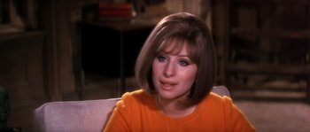 Movie still from “On a Clear Day You Can See Forever” (1970), directed by Vincente Minnelli – A person sitting on a couch; Close Up shot, Over the shoulder angle