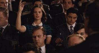 Movie still from “On the Basis of Sex” (2018), directed by Mimi Leder – A group of people sitting in a room; Medium shot, High angle