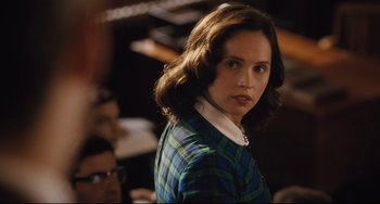 Movie still from “On the Basis of Sex” (2018), directed by Mimi Leder – A woman in a plaid shirt standing in front of a crowd; Close Up shot, Over the shoulder angle