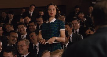 Movie still from “On the Basis of Sex” (2018), directed by Mimi Leder – A woman standing in front of a group of people; Medium shot, Over the shoulder angle