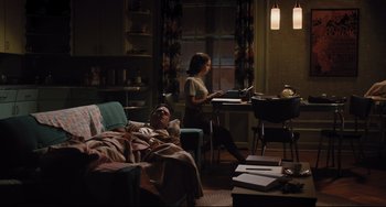 Movie still from “On the Basis of Sex” (2018), directed by Mimi Leder – Two people in a living room , one of which is sleeping; Wide shot, High angle