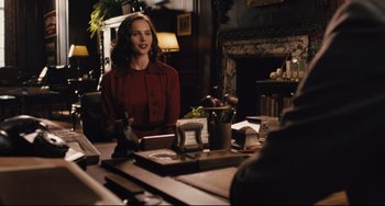 Movie still from “On the Basis of Sex” (2018), directed by Mimi Leder – A woman sitting in front of a mirror in a room; Medium shot, Over the shoulder angle