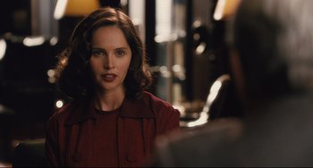 Movie still from “On the Basis of Sex” (2018), directed by Mimi Leder – A woman in a red jacket is looking at the camera; Close Up shot, Over the shoulder angle