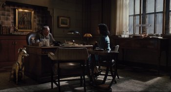 Movie still from “On the Basis of Sex” (2018), directed by Mimi Leder – A man and a woman sitting at a table in front of a window; Wide shot, High angle