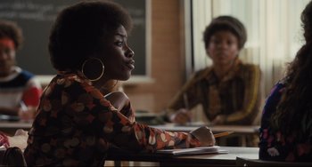 Movie still from “On the Basis of Sex” (2018), directed by Mimi Leder – A woman sitting at a table writing on a piece of paper; Medium shot, Over the shoulder angle