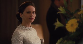 Movie still from “On the Basis of Sex” (2018), directed by Mimi Leder – A woman in a white dress sitting in front of a mirror; Close Up shot, Over the shoulder angle