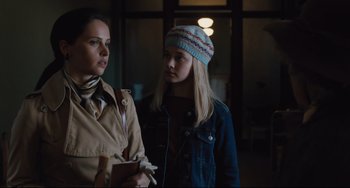 Movie still from “On the Basis of Sex” (2018), directed by Mimi Leder – A woman standing next to a young girl in front of a window; Medium shot, Low angle